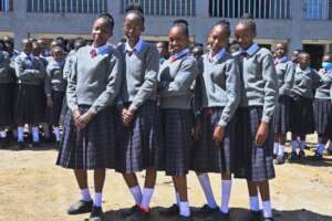 Girls show off their uniforms.