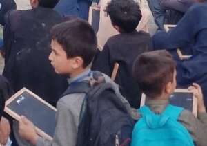 Determined young learners clutching their slates
