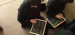 Students practicing Arabic script in school