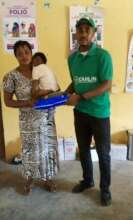Our Project Leader giving net to a nursing mother