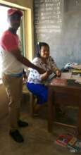 Our Project Leader paying children's school fees