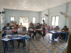 Students working on their literacy skills in Lahu
