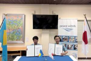 Country Rep Amma Nobumichi (left) signs program