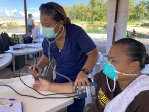 Blood pressure check at Peace Winds Palau booth