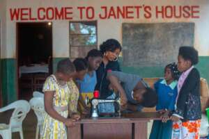 Children at Janet house learning how to sew