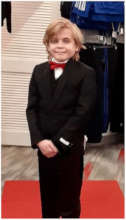 Wish kid Eric in his black suit and red bowtie