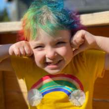 Wish kid Olivia with rainbow hair & a yellow shirt