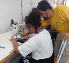 Maria Clara learning to use an industrial machine