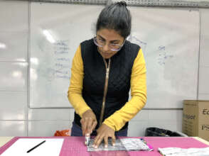 Our teacher Carol demonstrates the rotary cutter