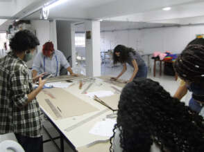 The teenagers learning how to pattern cut