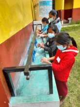 boys and girls wash their hands