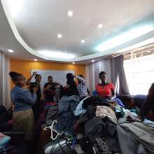 Image 13: Trainees selecting official wear  donate