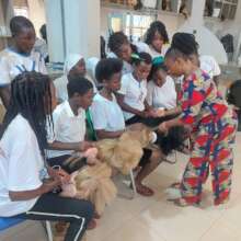 Hairdressing tutor teaching 1st year students