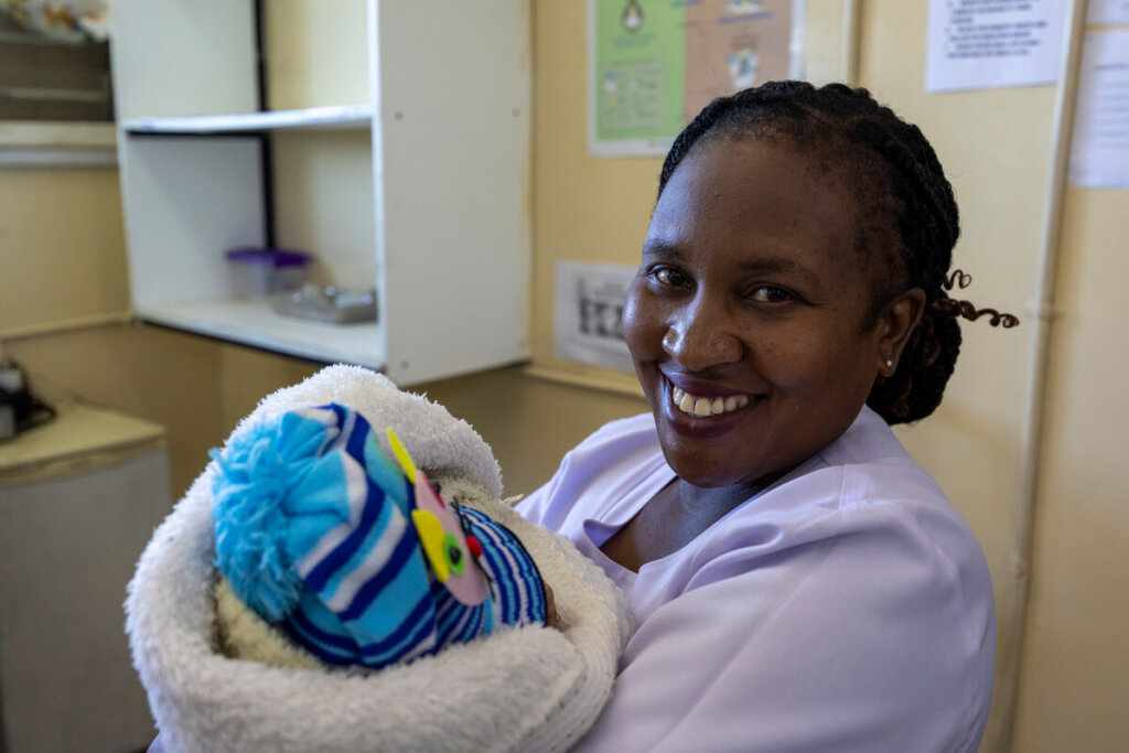 Nurse Patricia with newborn. Photo: David Brazier