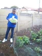 Zama student showing off school garden produce