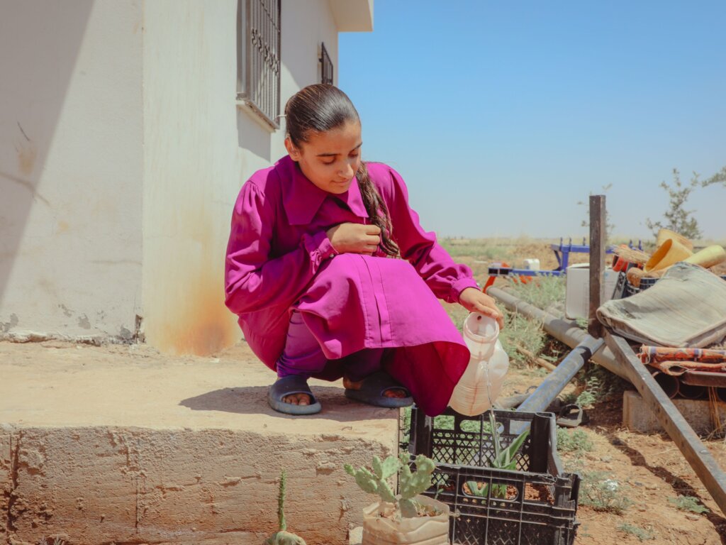 Merve watering plants Photo: IOM 2025/Mehmet Boran
