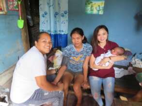 Midwives doing a postpartum home visit