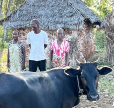 Amina (left) with Dad, Mum and her cow!