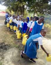 Pupils collect water from the new borehole