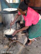 Mary the cook preparing maize flour