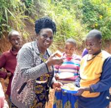 Head Teacher Mrs Mutua enjoying cake with students