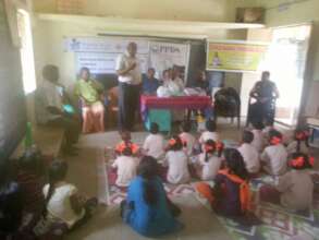 Distribution of note books to the children