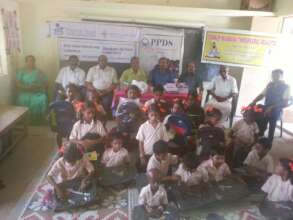 Distribution of note books to the children