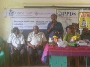 Distribution of note books to the children