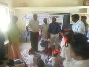 Distribution of note books to the children