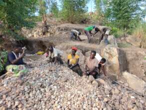 Quarry workers producing stones for concrete.