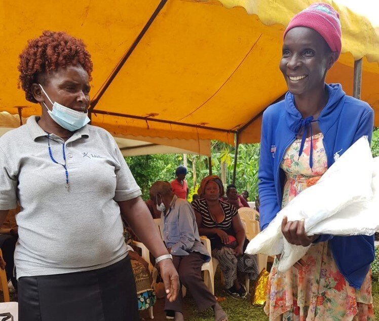 Joyce receives mosquito nets for her family.
