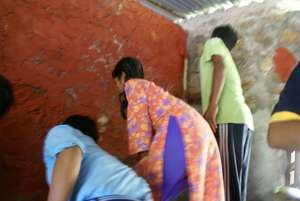 School children painting their classrooms.