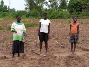 A Caregiver & Her Children Planting