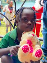 Caitlyn enjoys a cuddle with her first ever teddy!