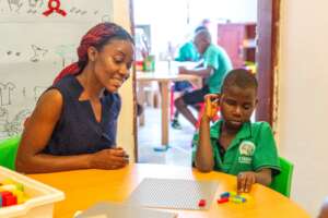 Teacher Joyce helping Slyvia read Braille