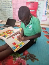Sylvia practicing for her test using Braille Lego
