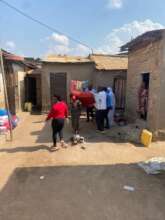 Palliative care team carrying Christine on her bed