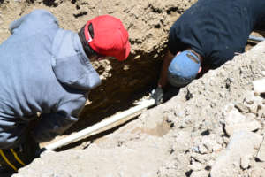 Joseph and Russell Laying the pipe