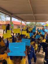 Grade 3 learners receiving certificates.