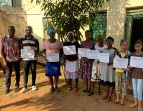 Proud graduates with certificates of achievement.