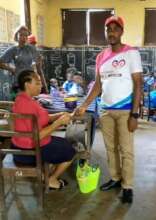 Our Project Leader paying a child's school fees