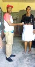 Our Project Leader paying school fees for a child