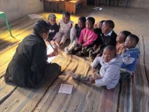 Reading with children at community preschool