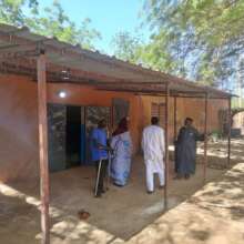 DIMA staff inspect the new sales shed at ANHL