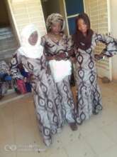 Tailoring students wearing outfits made in class