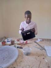 A leather working student in class