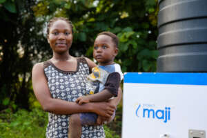 Mum and baby against the backdrop of a kiosk