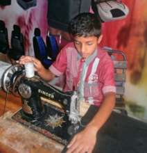 Ahsan sowing car seats at a car workshop