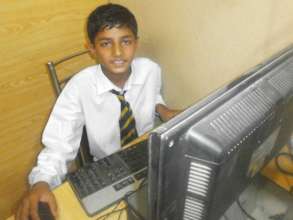 All smiles showing his seat in the computer lab