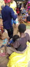 Our Project Leader giving food items to the women